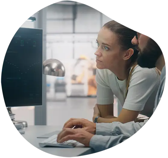 Zwei Personen blicken auf einen Monitor