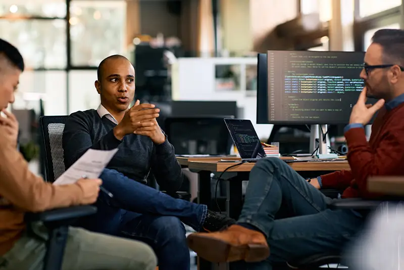 Mehrere Mitarbeiter besprechen Ihre Arbeit.